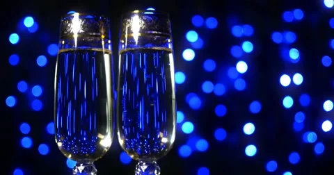 Bubbling champagne being poured into two crystal glasses against black Video stock 61551984