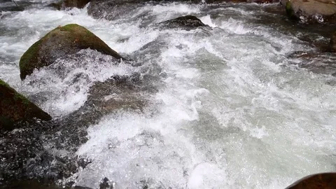 Bubbling flow of clean water over rocks Stockbeeldmateriaal 80901174