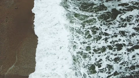 Bubbling foam sea waves run onto the sand Stock Footage 132174155