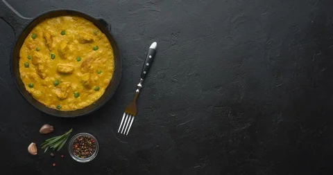 Bubbling hot chicken curry in pan with spices. Flat lay, top view with copy Stock Footage 120608165