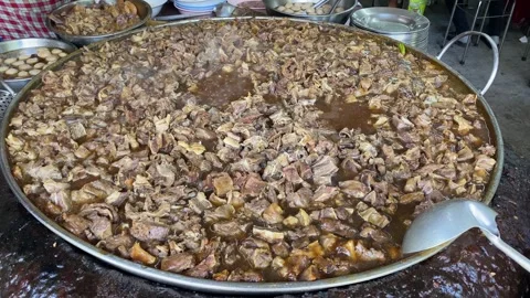 Bubbling hot stew meat pan in Wattana Panich restaurant, Bangkok, Thailand 4K Stock Footage 244704129