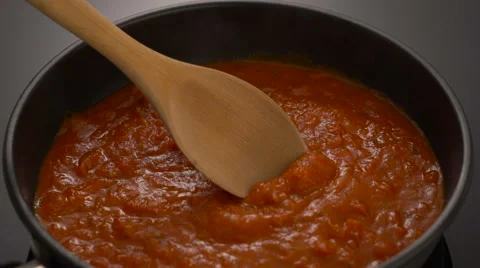 Bubbling hot tomato sauce for pasta, cooking in pan with wooden spatula Stock Footage 67854591
