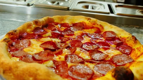 Bubbling ketchup and melted cheese create motion atop hot pizza Stock Footage 326368604