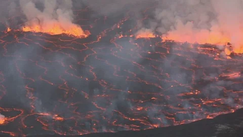 Bubbling lava and smoke in a round crater of Nyiragongo volcano, Congo Stock Footage 124080261