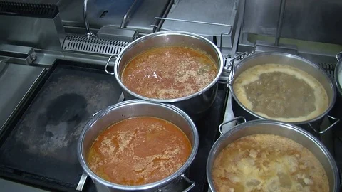 Bubbling meat soup, inside a metal pot, at a restaurant kitchen Stock Footage 90224745