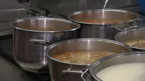 Bubbling meat soup, inside a metal pot, at a restaurant kitchen 動画素材 90224813
