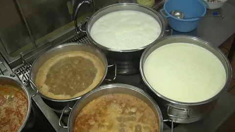 Bubbling meat soup, inside a metal pot, at a restaurant kitchen Stock Footage 90224847