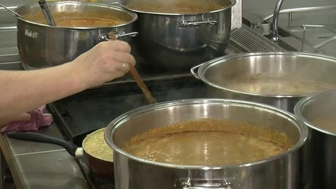 Bubbling meat soup, inside a metal pot, at a restaurant kitchen Stock Footage 90228580