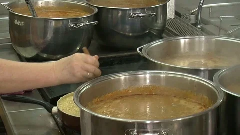 Bubbling meat soup, inside a metal pot, at a restaurant kitchen Stock Footage 90229363