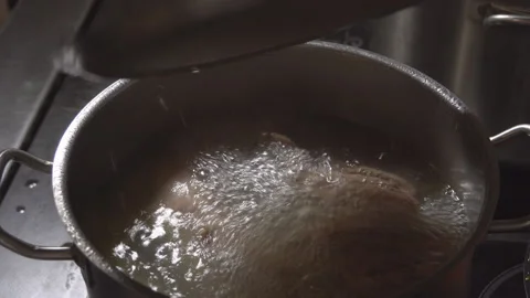Bubbling meat soup, inside a metal pot, at a restaurant kitchen Stock Footage 98070935