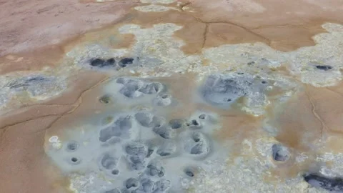 Bubbling mud pools on Namafjall mountain in Iceland, tilt reveal shot Stock-Footage 138737838