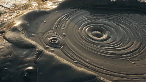 Bubbling mud pot at sunrise - Close up Stock Footage 56980490