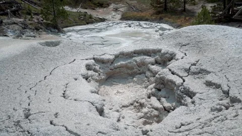 Bubbling mud pot in Yellowstone, releasing thick steam as mineral-rich mud boils Stock Footage 305570975