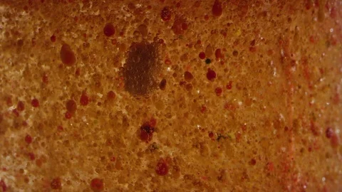 Bubbling orange and brown particles planet surface texture background Video stock 118295855