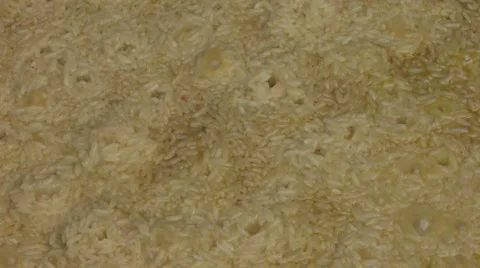 Bubbling pilaf in cauldron Stock Footage 960331