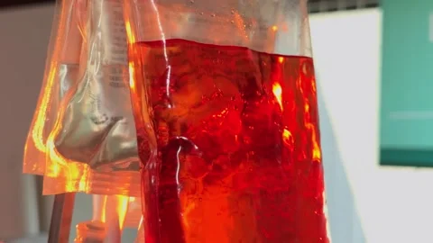 Bubbling red liquid filling up a plastic bag Stock Footage 342213120