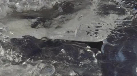 Bubbling River Ice Formation Crevice Pan to Flowing Water Stock Footage 12373786