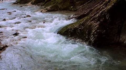 Bubbling stream of water next to  rock Stock-Footage 84735378