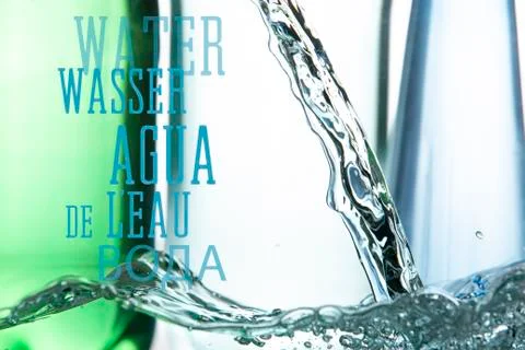 A bubbling surface and a stream of water against the background of plastic bo Stock Photos