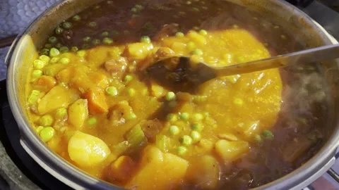 Bubbling Thick Stew with  Stirring Spoon Stock Footage 143492433