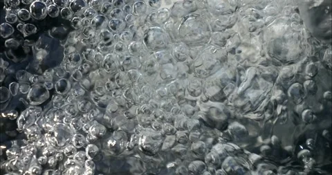 Bubbling water with air bubbles. Cavitation of water flow. Water texture. Stock Footage 337725272