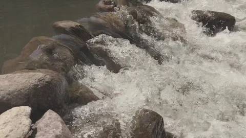 Bubbling water around rocks in river rapids Stock Footage 320949801