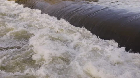 Bubbling water cascading down a river forming white foam Видео 297856679