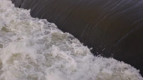 Bubbling water cascading down a river forming white foam Видео 297856683