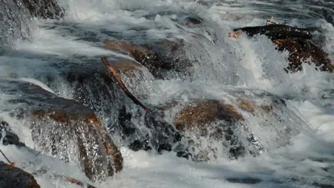 Bubbling water of mountain river on stone spurs close up, slow motion Stock Footage 178368870