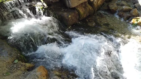 A bubbling waterfall on a small river Stock Footage 134908338