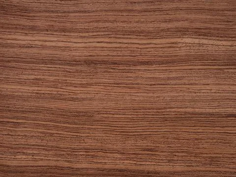 Bubinga veneer with distinctive wave patterns and warm reddish hues Stock Photos