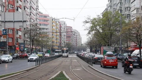 Bucharest City Tramway on Elevated Tracks and Cars Traffic Congestion on Street Stock Footage 106844181
