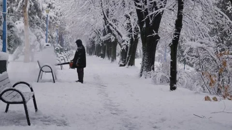 Bucharest, Romania - 01/20/2024: Man Using Leaf Blower To Remove Snow From Stock Footage 263012595