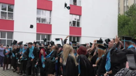 BUCHAREST,ROMANIA,.Blurred image of students throwing hats in the air. Stock Footage 68164055