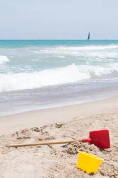 Bucket and shovel on the sand. Stock Photos