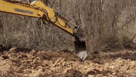 Bucket of backhoe digging soil at construction site. Crawler excavator digging Stock-Footage 205031708