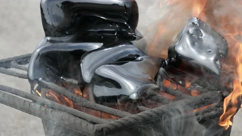 Bucket boiling tar resin on bricks. Pieces bitumen melted in bucket using burner Stock Footage 132080994