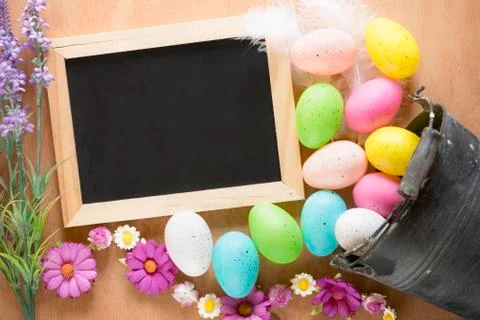 Bucket with Easter eggs and a chalkboard Stock Photos