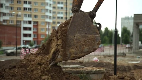 The bucket of excavator digs ground. Stock Footage 78184040