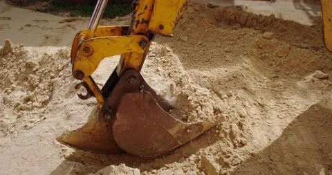 The bucket of the excavator digs the ground Stock Footage 140233822