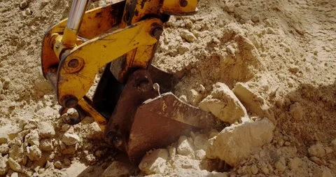 The bucket of the excavator digs the ground Stock Footage 140233858