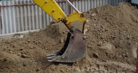 The bucket of the excavator digs the ground Stock Footage 140233983