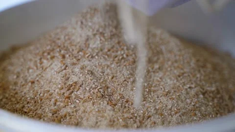 Bucket with ground wheat. close-up. The result of the grain crusher Stock Footage 308579427