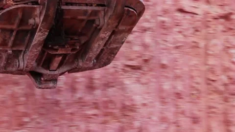 The bucket of a large mining excavator loads bauxite into the body of a huge Stock Footage 122215799