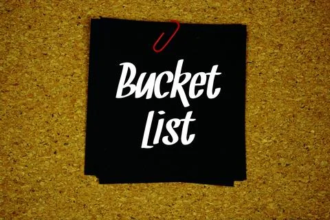 Bucket List text message on stick note on cork paper background Stock Photos