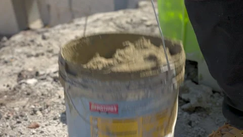 Bucket Of Mortar Picked Up By Labourer Stock Footage 239679635