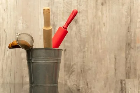 In the bucket is a set of various kitchen devices are made of wood. Copy spac Stock Photos