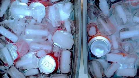 Bucket with soda cans surrounded by ice cubes. Refreshing drink to combat t.. Stock Footage 321895351