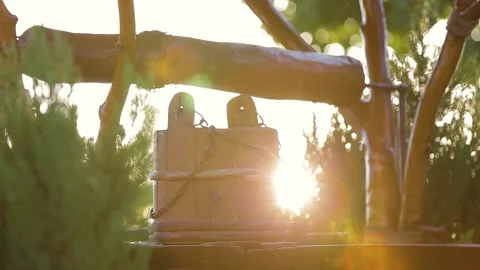 Bucket stands on a well at sunset Stock Footage 130797076