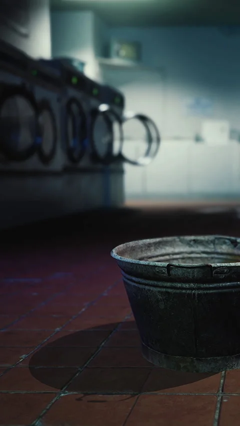 Bucket on tile floor in laundry room with washing machines Stock Footage 342187729